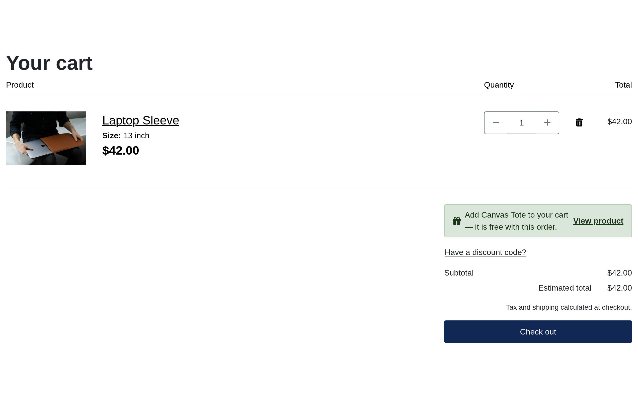 A Solidshop cart holding one Laptop Sleeve at 42.00 dollars, with a green notice beside the summary reading &ldquo;Add Canvas Tote to your cart &mdash; it is free with this order&rdquo; alongside a View product link